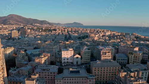 Drone sunset pullback view over Genoa skyline, Liguaria, Italy photo