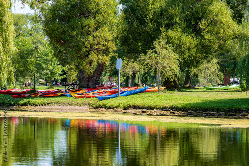 Photography colourful sea kayaks from a day camp on grass beside the water in the  toronto i