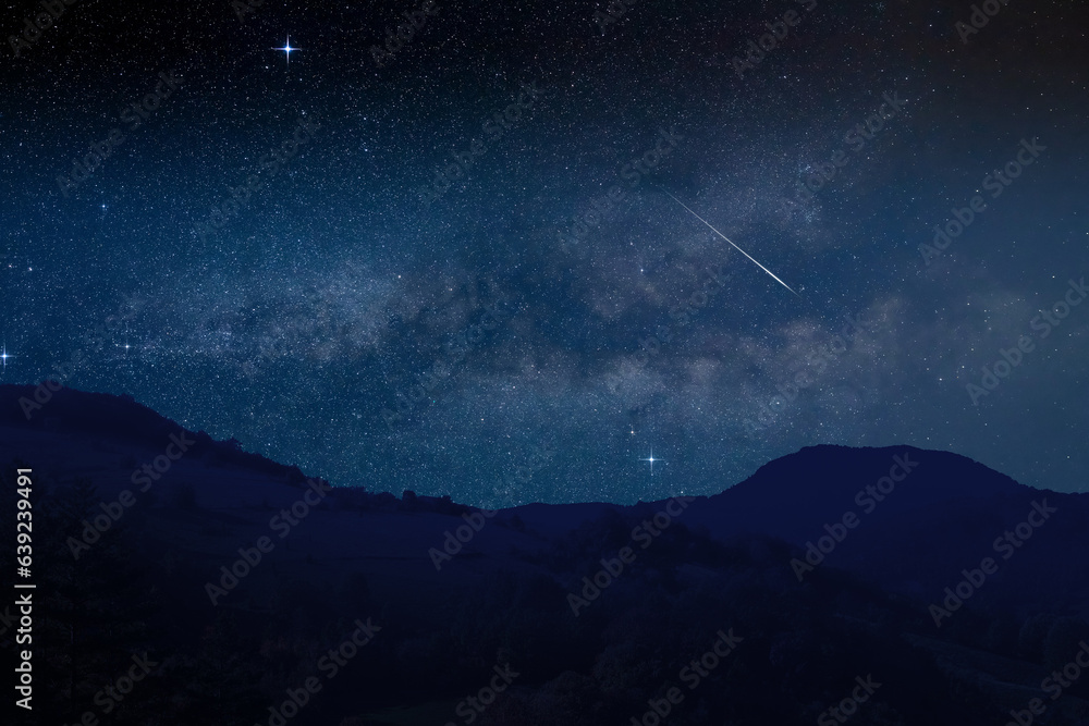 Shooting star, Milky way and landscape silhouettes.