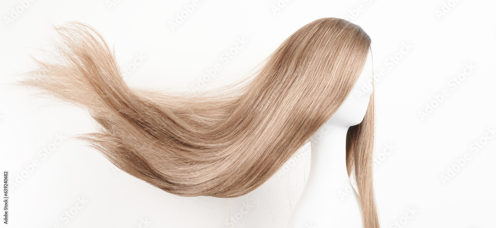 Natural looking dark blonde wig on white mannequin head. Long fair hair cut on the plastic wig holder isolated on white background Natural looking dark blonde wig on white mannequin head. Long fair hair cut on the plastic wig holder isolated on white background