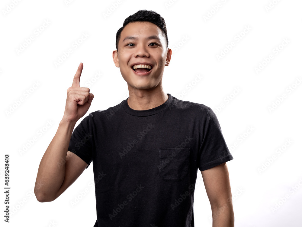 A portrait of an Asian man wearing a black t-shirt, pointing in a certain direction with both hands, isolated on a white background. A portrait of an Asian man wearing a black t-shirt, pointing in a certain direction with both hands, isolated on a white background.