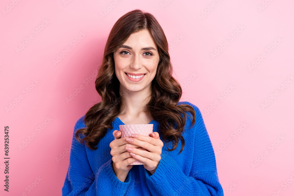 Photo portrait of attractive young woman hold coffee tea mug drinking wear trendy blue clothes isolated on pink color background Photo portrait of attractive young woman hold coffee tea mug drinking wear trendy blue clothes isolated on pink color background