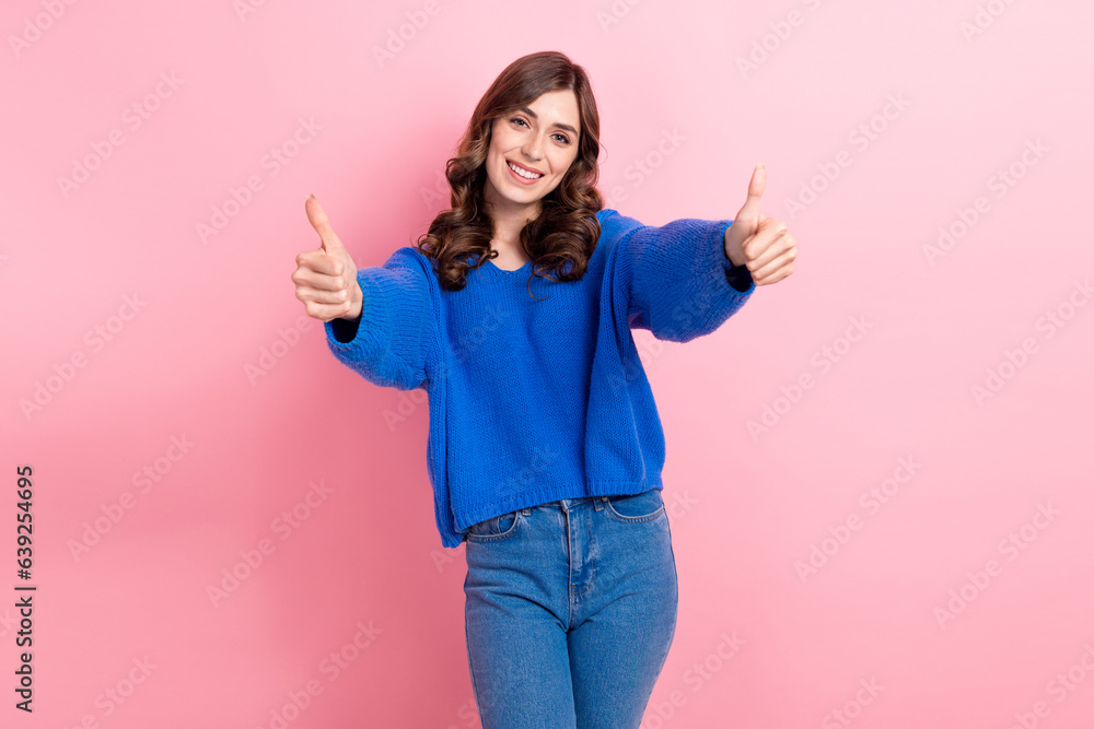 Photo portrait of lovely young lady showing double thumb up good quality wear trendy blue garment isolated on pink color background Photo portrait of lovely young lady showing double thumb up good quality wear trendy blue garment isolated on pink color background