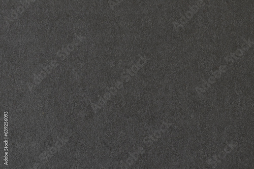 Texture of black packaging cardboard. Background from black cardboard.
