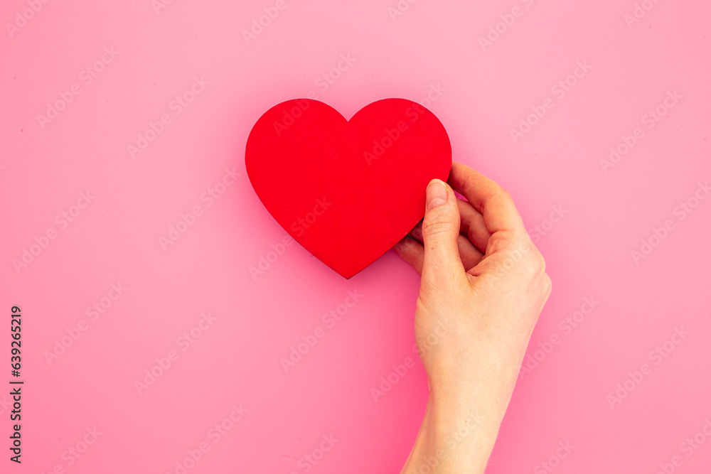 Red heart with woman hands, top view. Health care and love concept Red heart with woman hands, top view. Health care and love concept