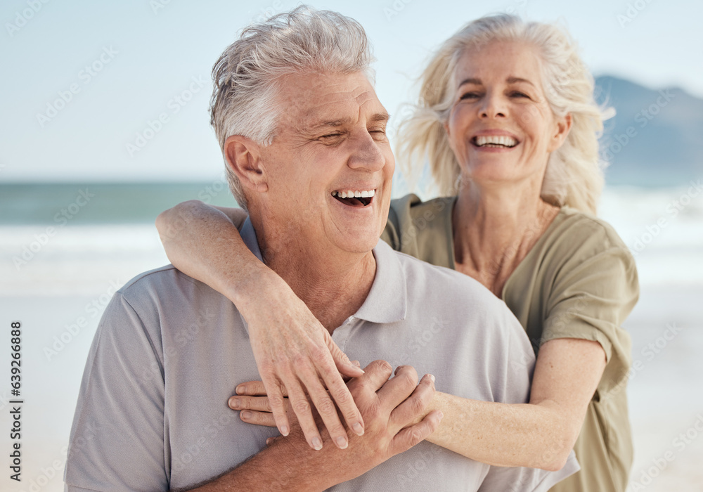 Senior, happy couple and hug on beach in support, love or care for bonding, weekend or break together. Elderly man and woman smile in happiness for holiday, vacation or outdoor getaway on ocean coast