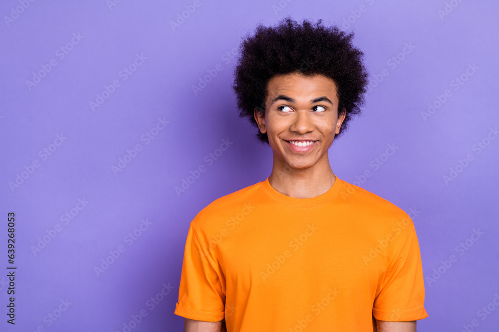 Photo of cheerful creative minded person beaming smile look empty space isolated on violet color background Photo of cheerful creative minded person beaming smile look empty space isolated on violet color background