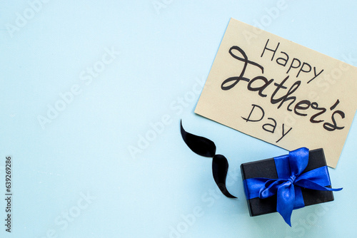 Gift box with blue ribbon for Happy Fathers day. Greeting card concept