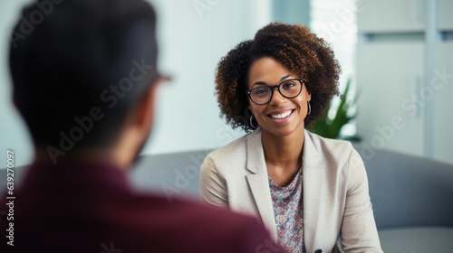 Young happy woman talking with psychologist at clinic, session of rehab therapy