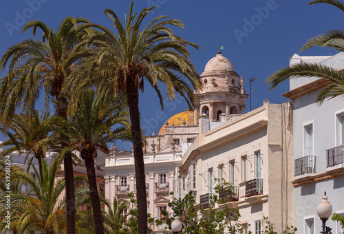 The dome and bell tower of the cathedral against the blue sky in Cadiz.