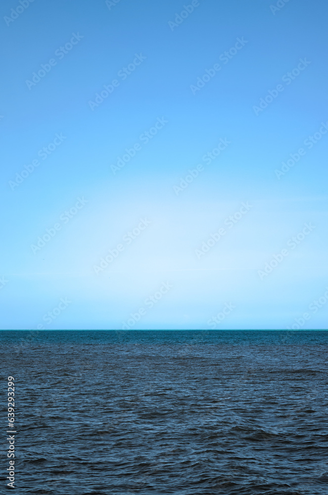 Riohacha, Colombia - January 2 2023: blue sky with multicolor sea