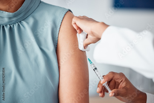 Hands, medical and doctor with patient for vaccine in a clinic for healthcare treatment for prevention. Closeup of a nurse doing a vaccination injection with a needle syringe in a medicare hospital. photo