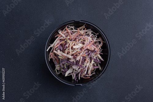 Delicious cabbage salad on a dark background, delivery, close up 