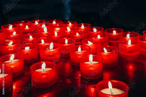 Close-up of red candles in the cathedral of the city of Como in Italy