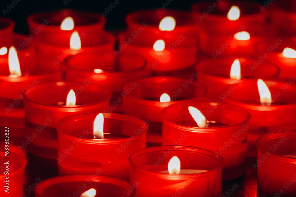 Close-up of red candles in the cathedral of the city of Como in Italy Close-up of red candles in the cathedral of the city of Como in Italy