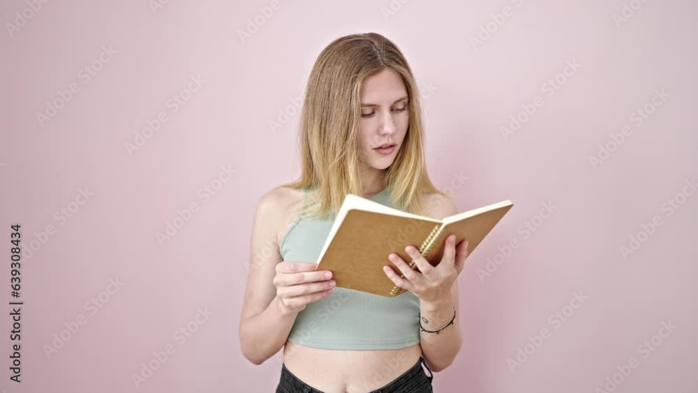 Young blonde woman reading book thinking over isolated pink background Young blonde woman reading book thinking over isolated pink background