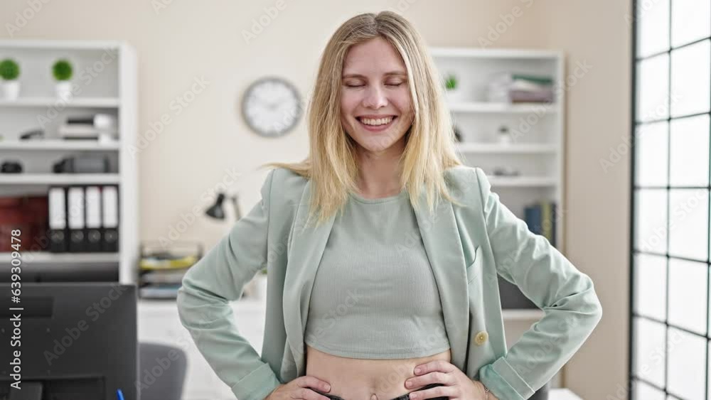 Young blonde woman business worker smiling confident standing at office Young blonde woman business worker smiling confident standing at office
