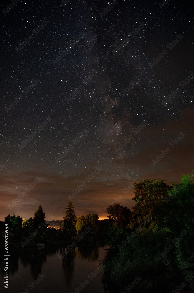 Long time exposure night landscape with Milky Way galaxy on the sky during the Meteor Shower Perseids. Shooting star.