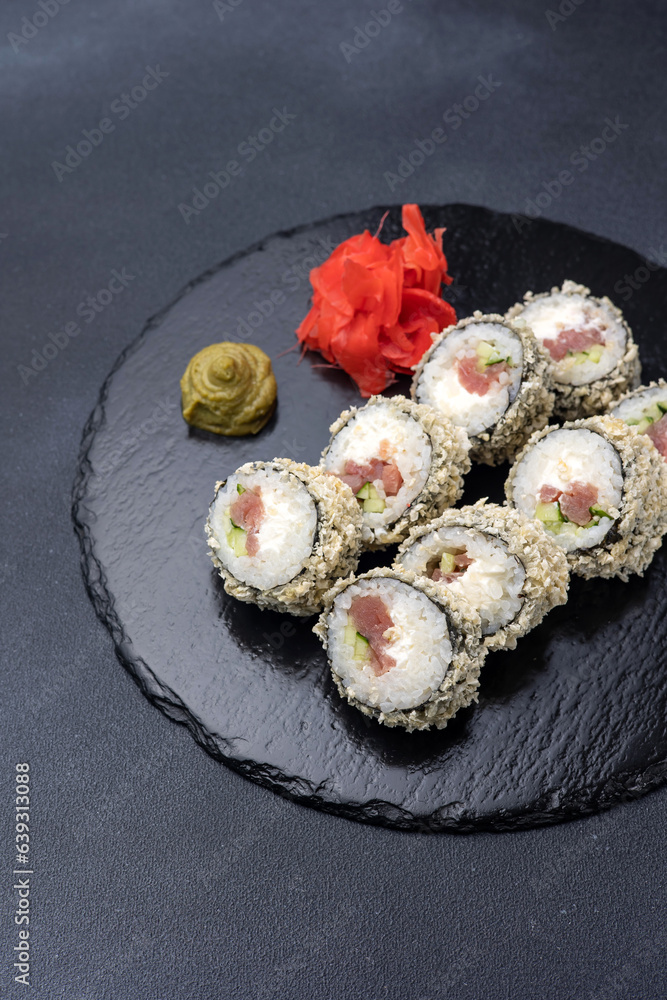 Delicious rolls on a dark background. Japanese cuisine. Close up Delicious rolls on a dark background. Japanese cuisine. Close up