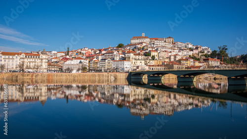 View of the old town of Coimbra reflected in the river, Portugal. photo