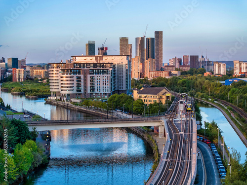 Print op canvas Rail tracks and a bridge over the Irewll river leading to Manchester skyline