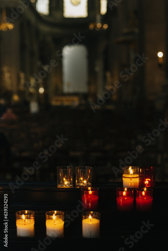 Burning candles in an old church. © Inna