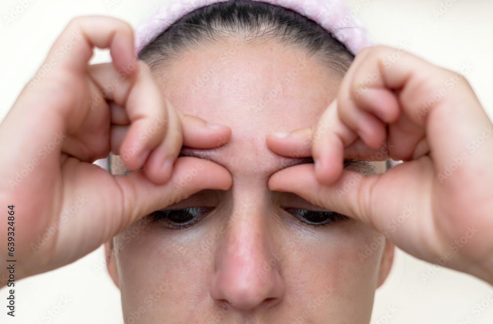 millennial woman practising facial massage yoga exercises for natural rejuvenation close up half face,clean skin. girl with hands on face millennial woman practising facial massage yoga exercises for natural rejuvenation close up half face,clean skin. girl with hands on face