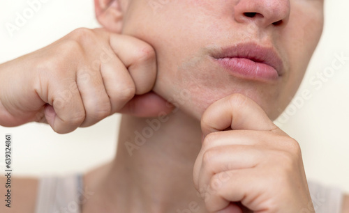 Canvas Print millennial woman practising facial massage yoga exercises for natural rejuvenation close up half face,clean skin