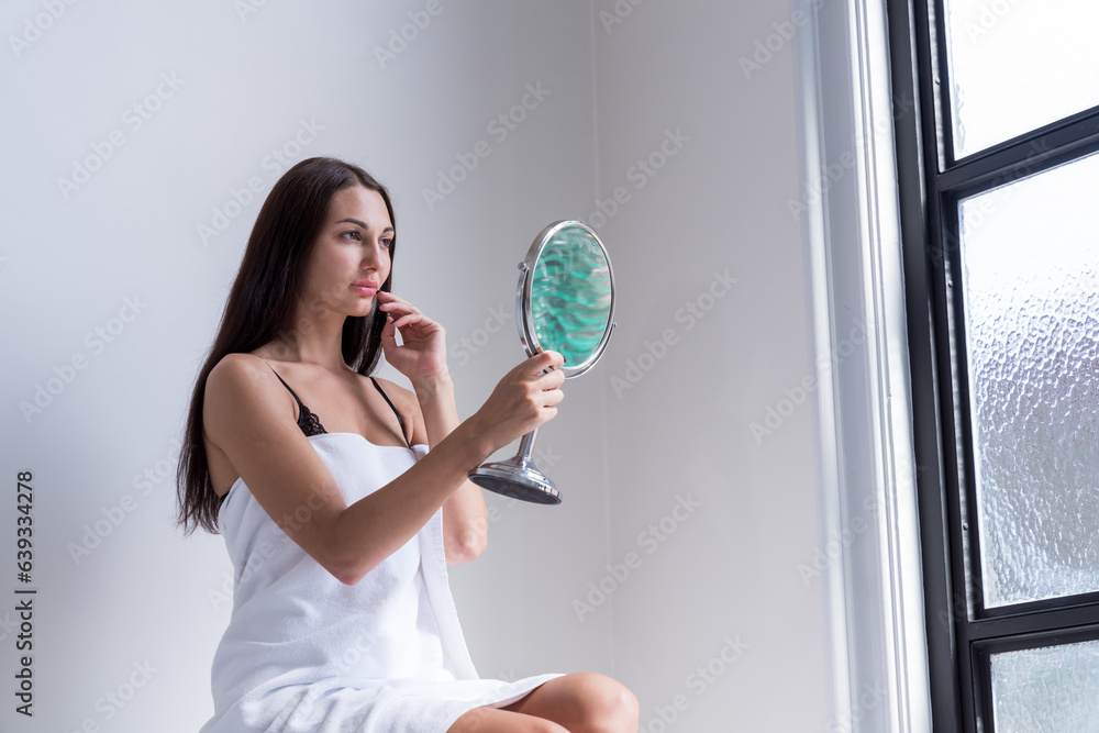 Sexy woman standing by the window with her shirt off Sexy woman standing by the window with her shirt off
