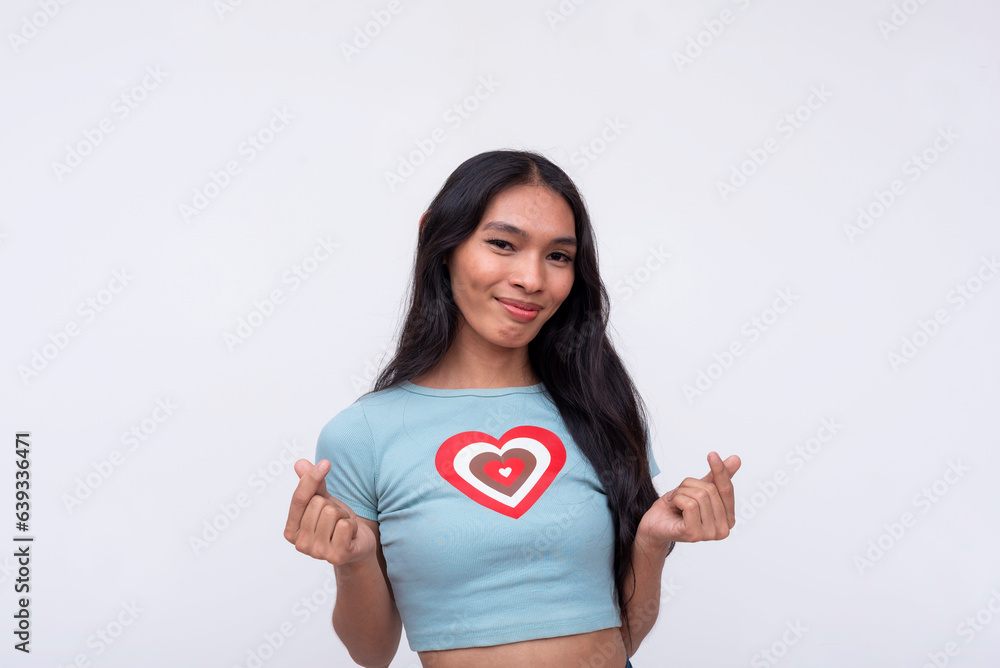 A happy and upbeat trans woman makes a heart finger gesture with both hands. Isolated on a white backdrop. A happy and upbeat trans woman makes a heart finger gesture with both hands. Isolated on a white backdrop.