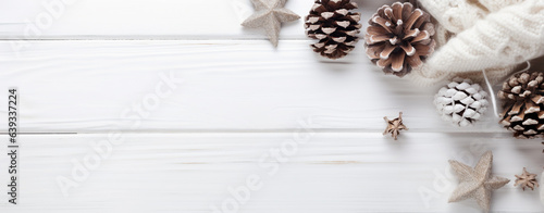 Christmas card with a piece of woolen fabric with pine cones on a white wooden table with copy space, legal AI