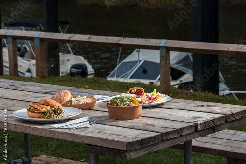 A meal set for a hearty lunch for two at an Italian café - burgers, appetizer, French fries, food photo