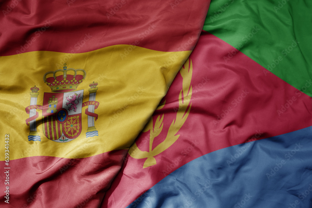 big waving national colorful flag of spain and national flag of eritrea . big waving national colorful flag of spain and national flag of eritrea .