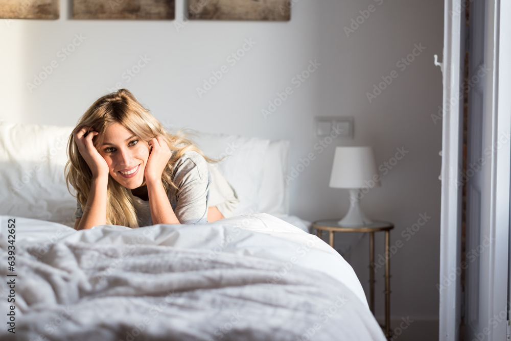 happy beautiful young women smiling on bed happy beautiful young women smiling on bed