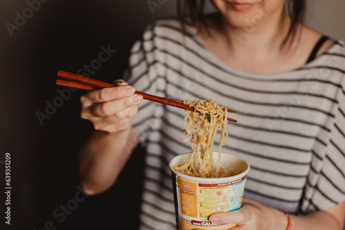 Photography young woman eating instant noodles