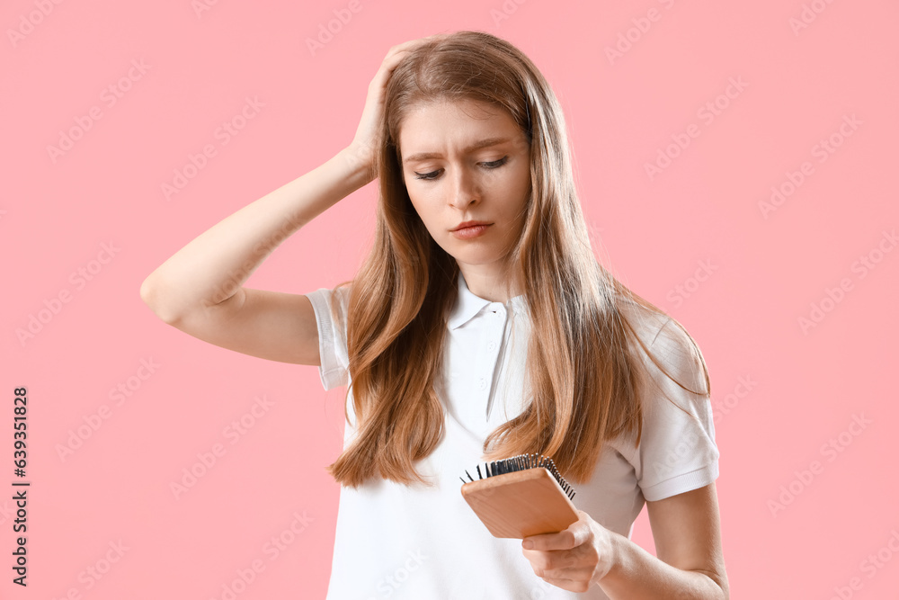 Worried young woman with hair loss problem and brush on pink background Worried young woman with hair loss problem and brush on pink background