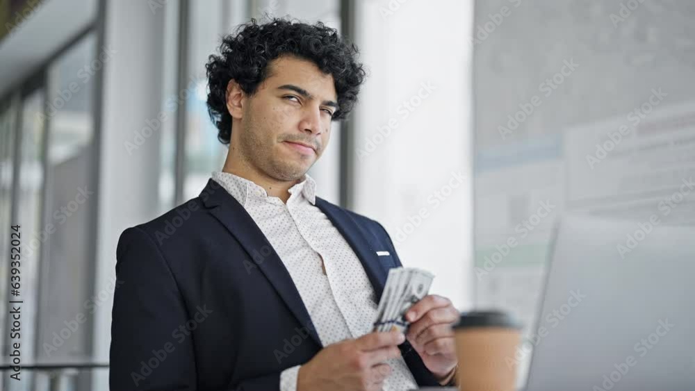 Young latin man business worker holding dollars thinking at office Young latin man business worker holding dollars thinking at office