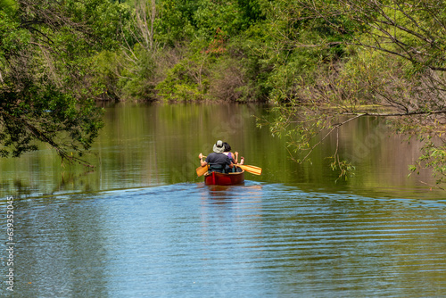 A Couple Paddling A Canoe On The River In Summer In Wisconsin