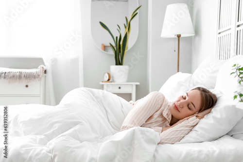 Obraz na plátně Young woman sleeping in bed at home