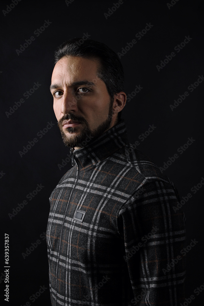 Naklejka premium Male portrait on a dark background.