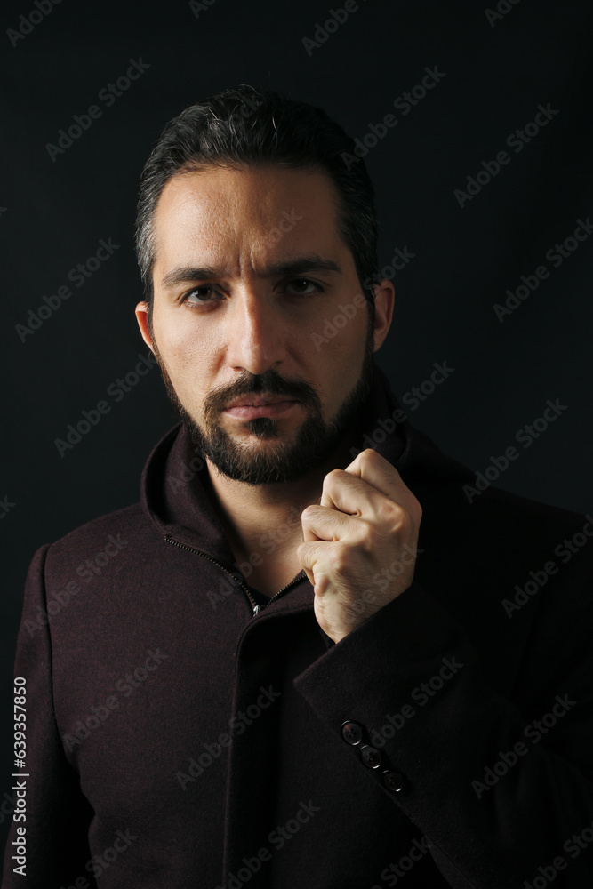 Male portrait on a dark background.