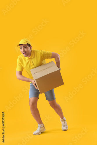 Male courier with parcel ru...
