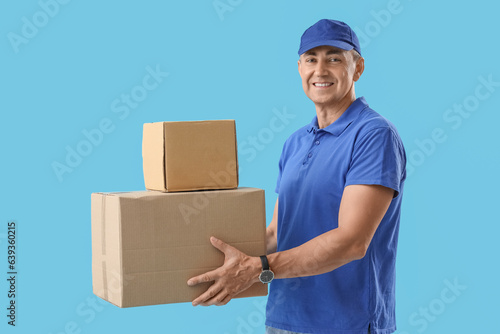 Mature courier with parcels...