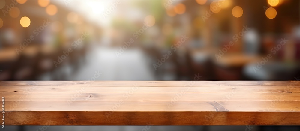 Wooden table in coffee shop with abstract background can be used for product display or montage Wooden table in coffee shop with abstract background can be used for product display or montage