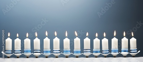 A white menorah adorned with blue and white candles