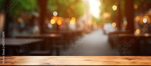 Blurry cafe backdrop with an empty wooden table
