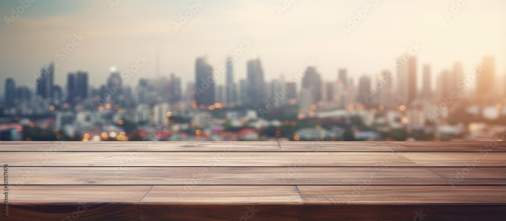 Blur cityscape background with empty wooden tabletop or desk space for text