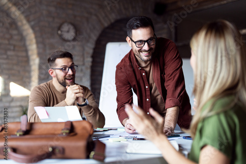 Group of young business team speaking in office photo