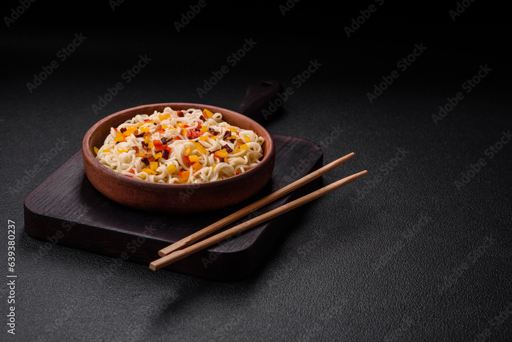 Delicious fresh Asian noodles with pieces of vegetables, meat, with salt, spices and herbs Delicious fresh Asian noodles with pieces of vegetables, meat, with salt, spices and herbs