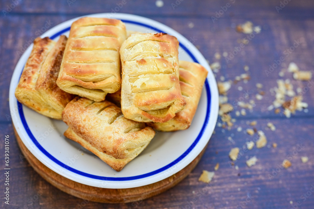 Fresh baked home made Mini cheese puff pastries and cream spread cheese.Cheese pie with phyllo pastry and herbs Fresh baked home made Mini cheese puff pastries and cream spread cheese.Cheese pie with phyllo pastry and herbs